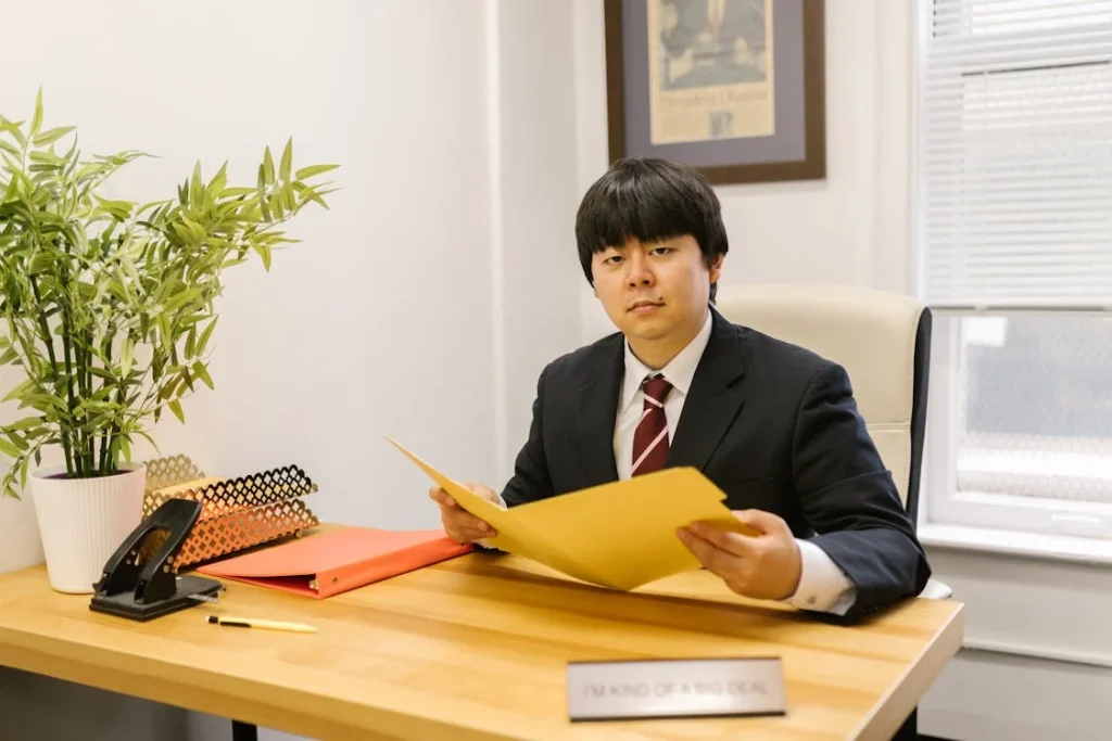 A Man in Black Suit Holding a Folder